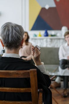 A therapist leads a couple's therapy session in a modern office setting.
